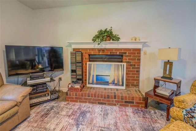 living room featuring hardwood / wood-style flooring and a fireplace