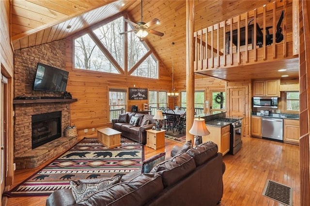 living room featuring light hardwood / wood-style flooring, high vaulted ceiling, and a wealth of natural light