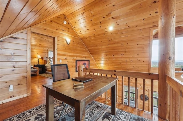 office area with wooden walls, lofted ceiling, hardwood / wood-style floors, and wooden ceiling