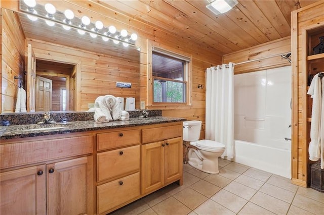 full bathroom featuring wood walls, tile patterned floors, shower / bath combo with shower curtain, vanity, and toilet