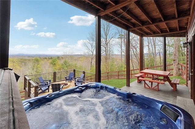 deck featuring a fire pit and a hot tub