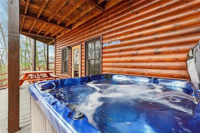 wooden deck featuring a hot tub