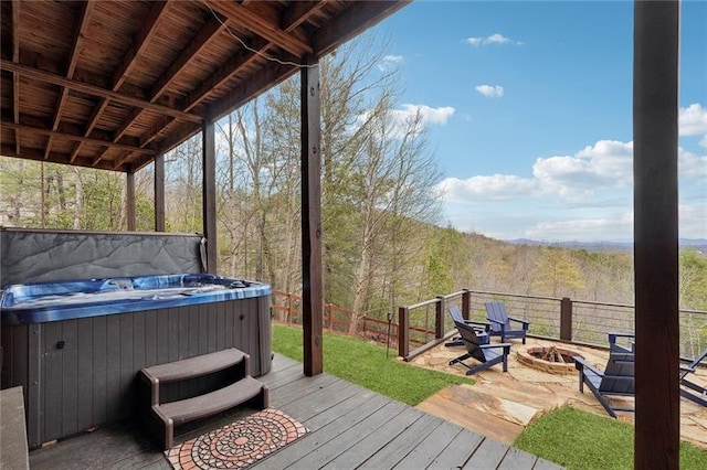 wooden terrace featuring a hot tub and an outdoor fire pit