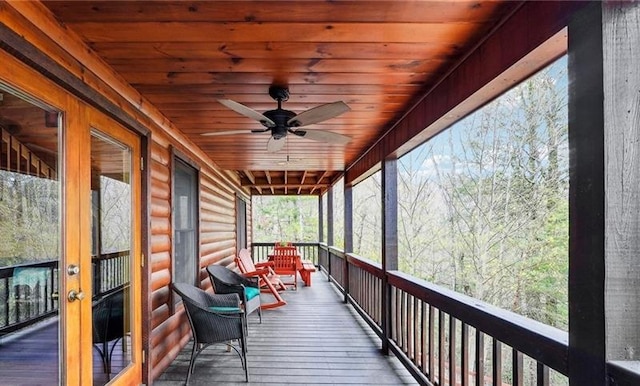 sunroom / solarium with ceiling fan and wooden ceiling