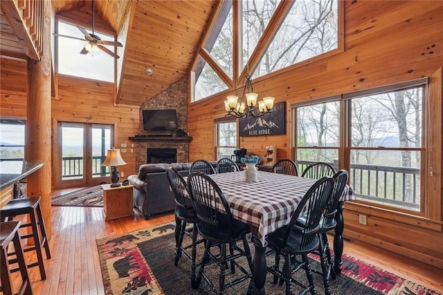 dining area featuring high vaulted ceiling, a wealth of natural light, and hardwood / wood-style floors