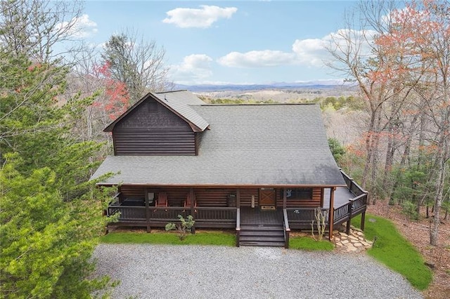 log cabin with a wooden deck