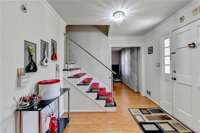 foyer featuring hardwood / wood-style flooring and crown molding