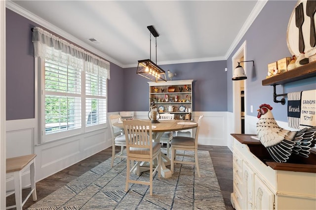 3392 Fall Branch Ln, Buford, GA 30519 - dining space featuring dark wood-style floors, crown molding, wainscoting, and a decorative wall
