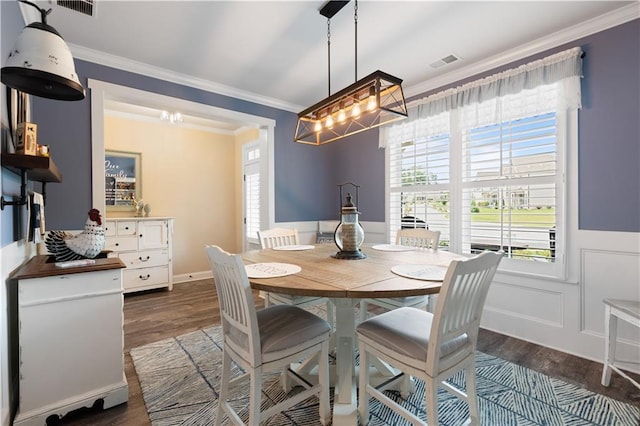 3392 Fall Branch Ln, Buford, GA 30519 - dining space featuring dark wood-style floors, crown molding, a chandelier, and wainscoting