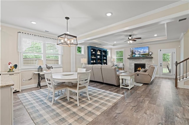 3392 Fall Branch Ln, Buford, GA 30519 - dining room with light wood-style flooring, healthy amount of natural light, a stone fireplace, a chandelier, and recessed lighting