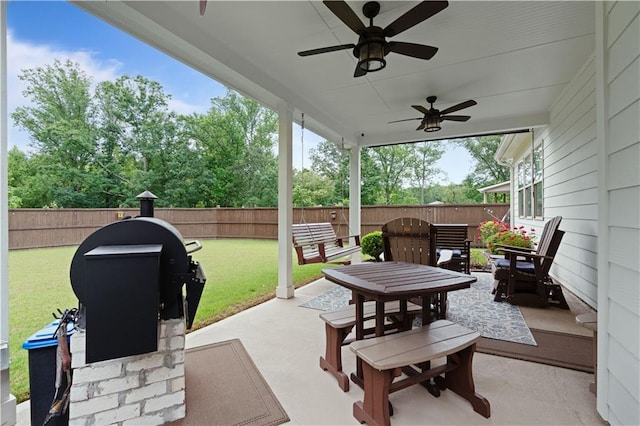 3392 Fall Branch Ln, Buford, GA 30519 - fenced backyard featuring ceiling fan, a patio, and outdoor dining space
