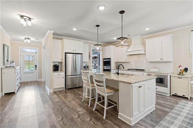 3392 Fall Branch Ln, Buford, GA 30519 - kitchen featuring appliances with stainless steel finishes, custom exhaust hood, crown molding, dark wood-type flooring, and a kitchen breakfast bar