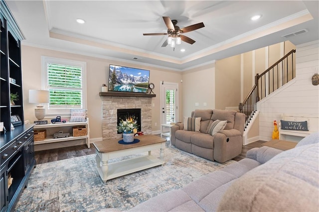3392 Fall Branch Ln, Buford, GA 30519 - living area with a tray ceiling, wood finished floors, stairway, plenty of natural light, and ornamental molding