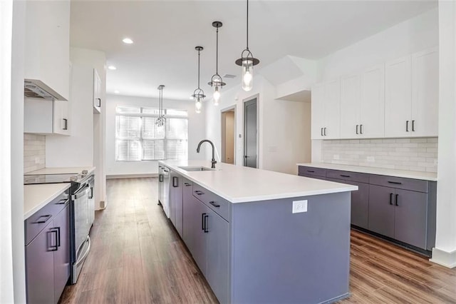 1250 Oxley Ln NW, Atlanta, GA 30307 - kitchen with appliances with stainless steel finishes, a sink, wood finished floors, light countertops, and recessed lighting
