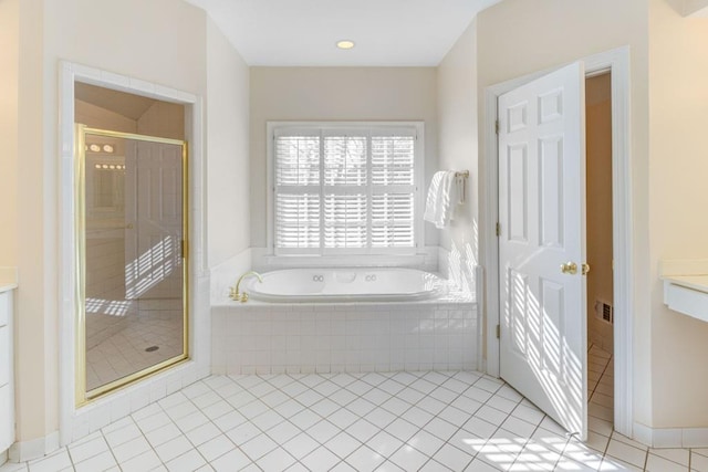 full bathroom with a stall shower, a garden tub, vanity, and tile patterned floors