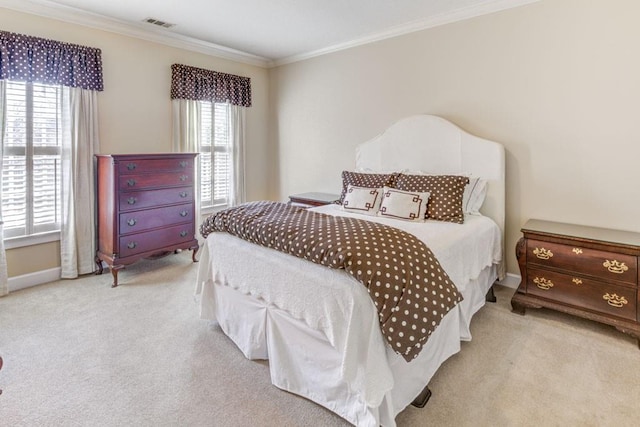 bedroom with carpet floors, ornamental molding, visible vents, and baseboards