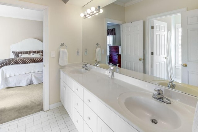 bathroom with tile patterned floors, crown molding, a sink, and ensuite bathroom