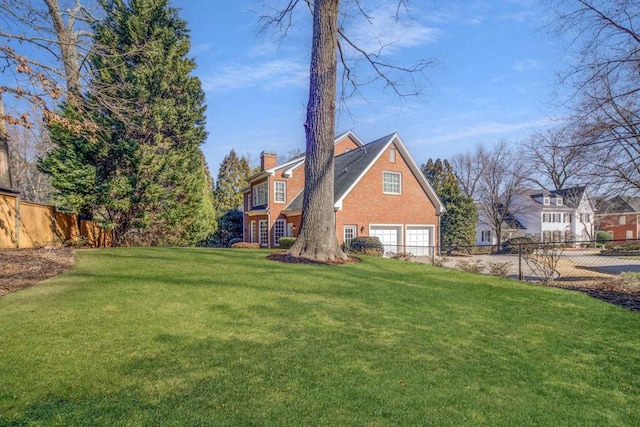 view of home's exterior with a chimney, fence, and a yard