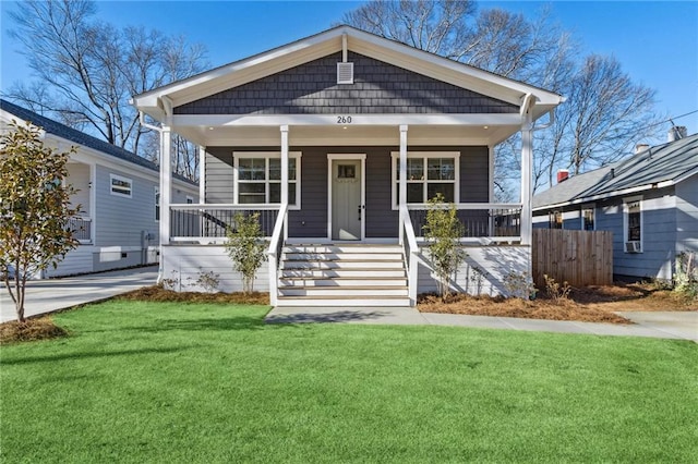 view of front of property featuring a porch and a front lawn