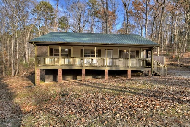 view of front facade featuring a porch and metal roof