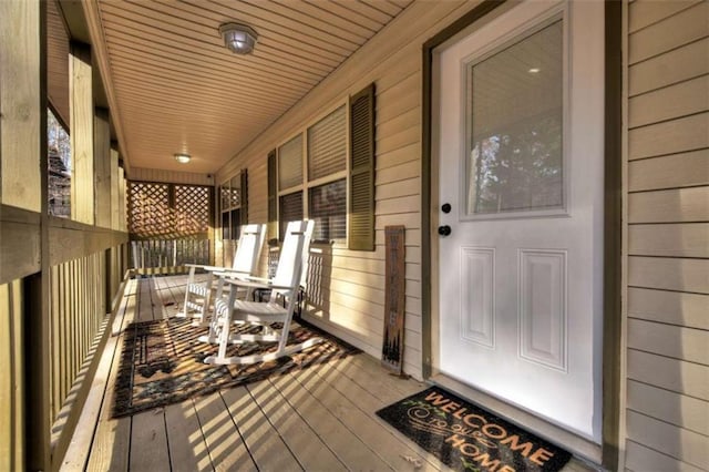 wooden terrace featuring covered porch