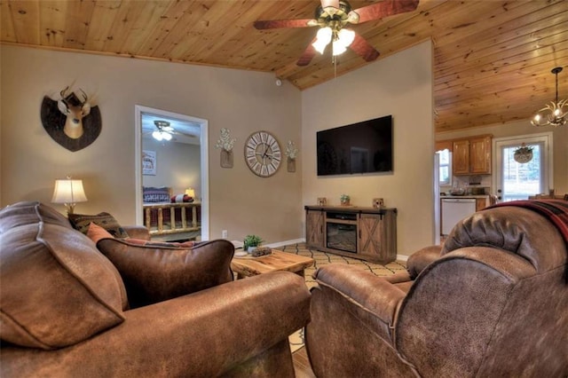 living room with baseboards, wood ceiling, lofted ceiling, ceiling fan with notable chandelier, and a fireplace