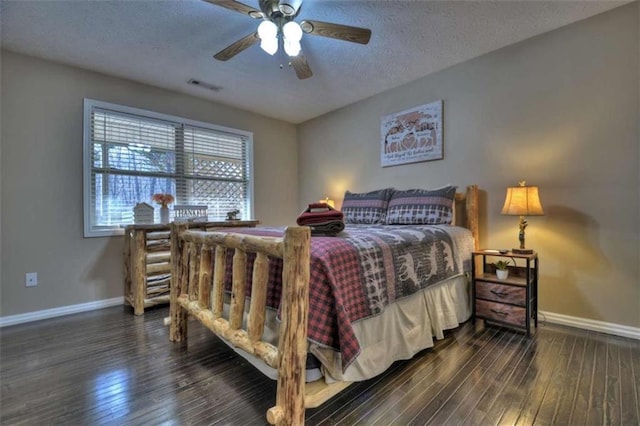 bedroom with visible vents, a textured ceiling, baseboards, ceiling fan, and dark wood-style flooring