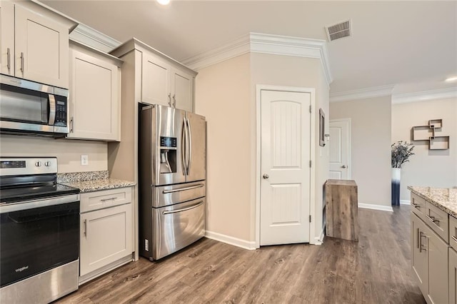 3070 Fareed St, Douglasville, GA 30135 - kitchen featuring stainless steel appliances, ornamental molding, baseboards, dark wood-style floors, and light stone countertops