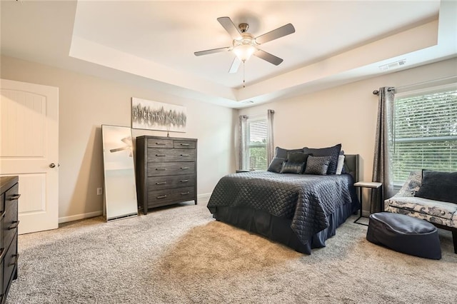 3070 Fareed St, Douglasville, GA 30135 - carpeted bedroom featuring a tray ceiling, a ceiling fan, and baseboards
