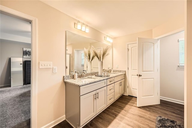 3070 Fareed St, Douglasville, GA 30135 - bathroom with double vanity, wood finished floors, and baseboards
