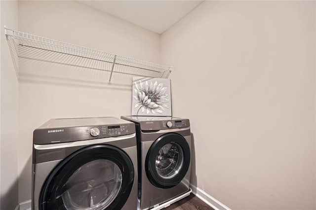 3070 Fareed St, Douglasville, GA 30135 - washroom featuring independent washer and dryer, baseboards, and wood finished floors