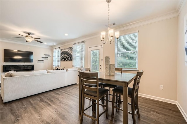 3070 Fareed St, Douglasville, GA 30135 - dining space featuring crown molding, dark wood finished floors, a chandelier, baseboards, and a ceiling fan