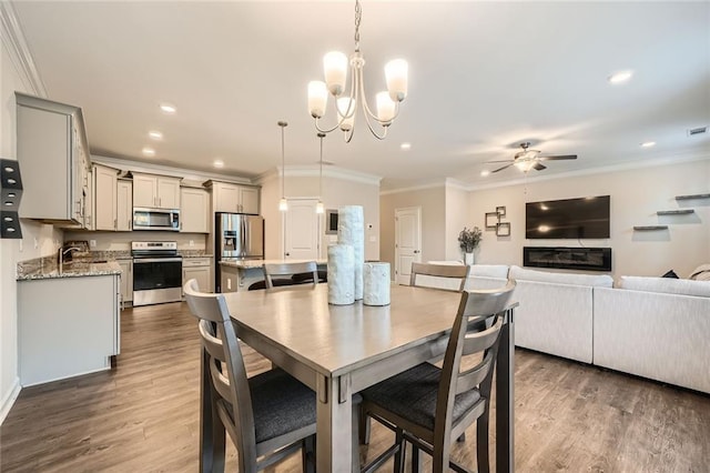 3070 Fareed St, Douglasville, GA 30135 - dining space featuring ornamental molding, wood finished floors, a ceiling fan, recessed lighting, and a chandelier