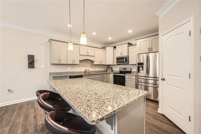 3070 Fareed St, Douglasville, GA 30135 - kitchen featuring appliances with stainless steel finishes, ornamental molding, a kitchen bar, gray cabinets, and recessed lighting