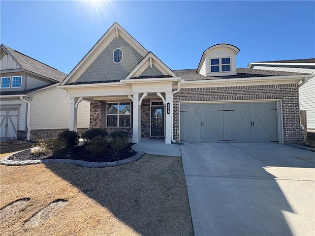 view of front of property featuring concrete driveway, brick siding, and an attached garage