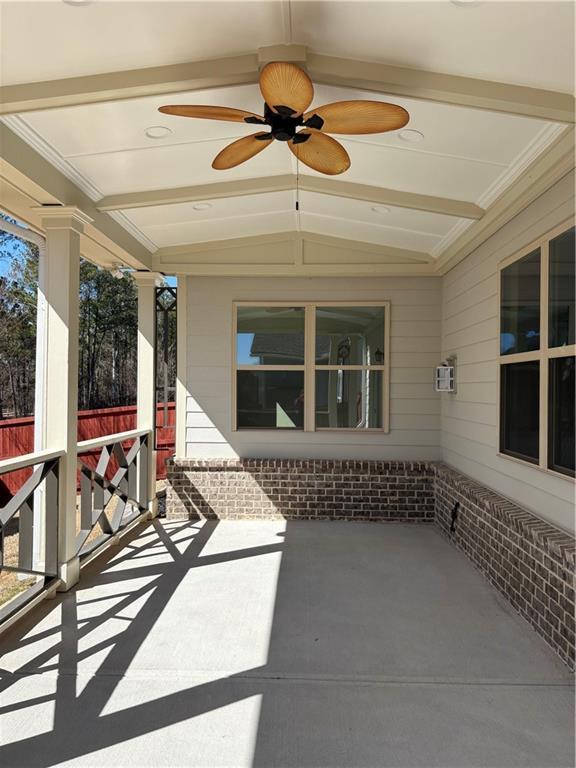 view of patio / terrace with a ceiling fan and fence