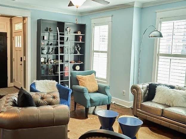 sitting room with ceiling fan, a healthy amount of sunlight, wood-type flooring, and ornamental molding