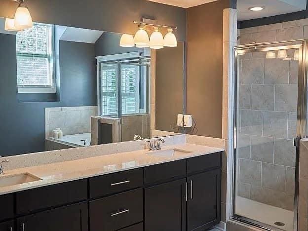 bathroom featuring separate shower and tub and vanity