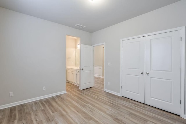 unfurnished bedroom featuring a closet and light hardwood / wood-style floors