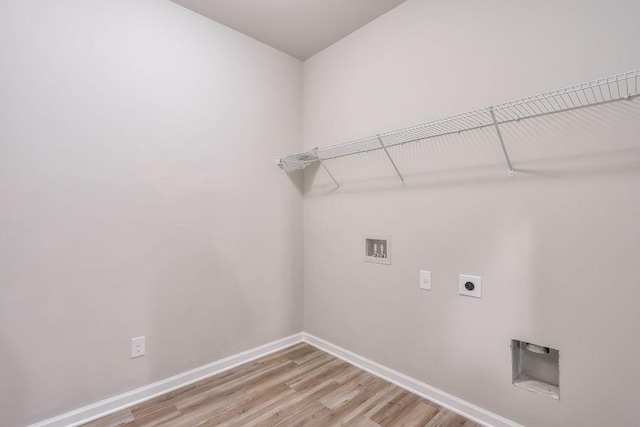 clothes washing area featuring hookup for a washing machine, wood-type flooring, and hookup for an electric dryer