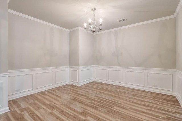 unfurnished room with light hardwood / wood-style floors, a chandelier, and crown molding