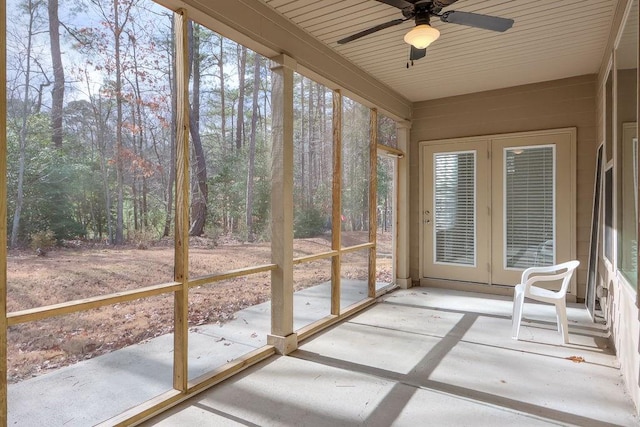 unfurnished sunroom featuring ceiling fan