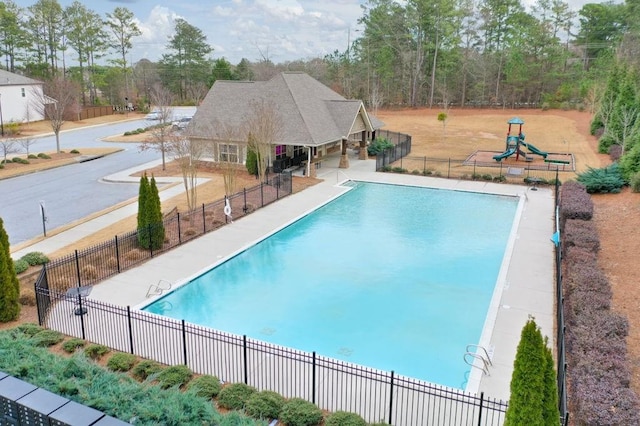 view of swimming pool featuring a playground