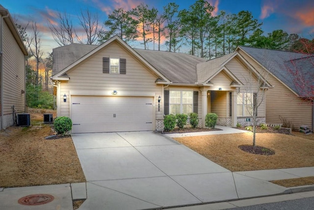 view of front of house featuring a garage and central AC unit