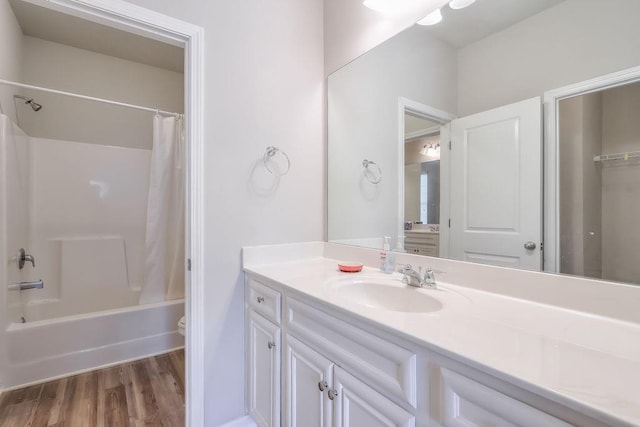 full bathroom featuring hardwood / wood-style flooring, vanity, toilet, and shower / bath combo with shower curtain