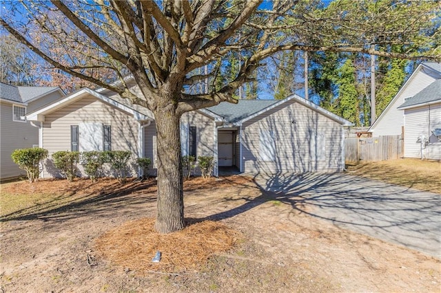 single story home with fence and driveway