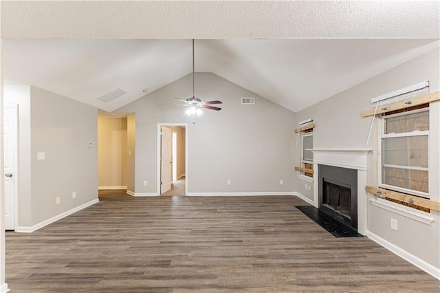 unfurnished living room featuring a fireplace with flush hearth, baseboards, vaulted ceiling, and wood finished floors