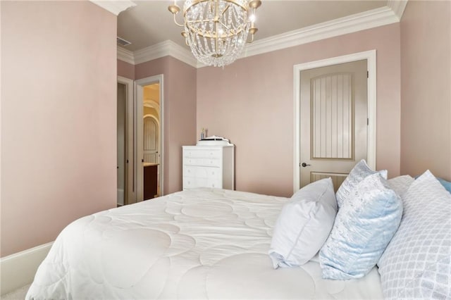 bedroom with ornamental molding and an inviting chandelier