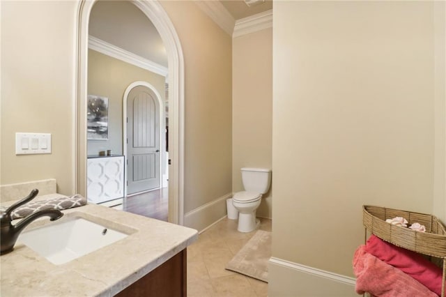 bathroom with vanity, tile patterned flooring, crown molding, and toilet