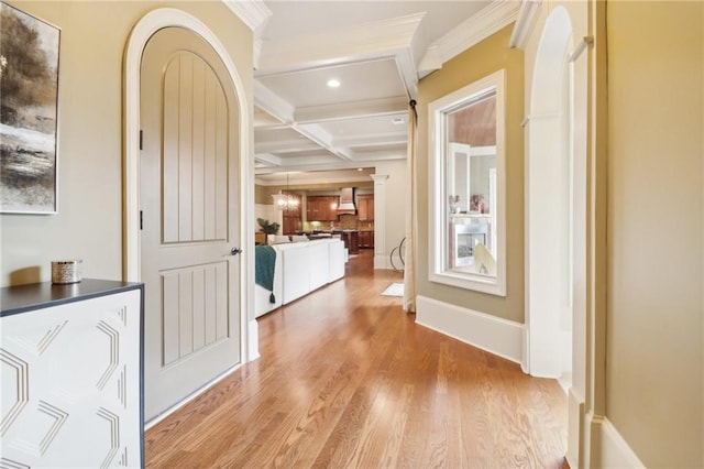 corridor featuring coffered ceiling, crown molding, light hardwood / wood-style flooring, and beamed ceiling